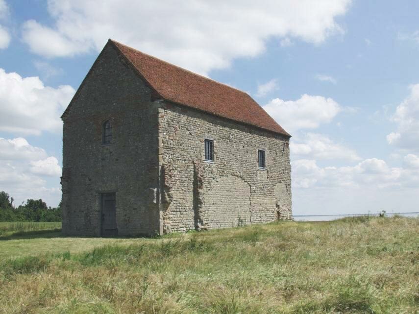 Scene showing the Saxon chapel of St. Peter on the Wall, Bradwell-on-Sea, Essex, England