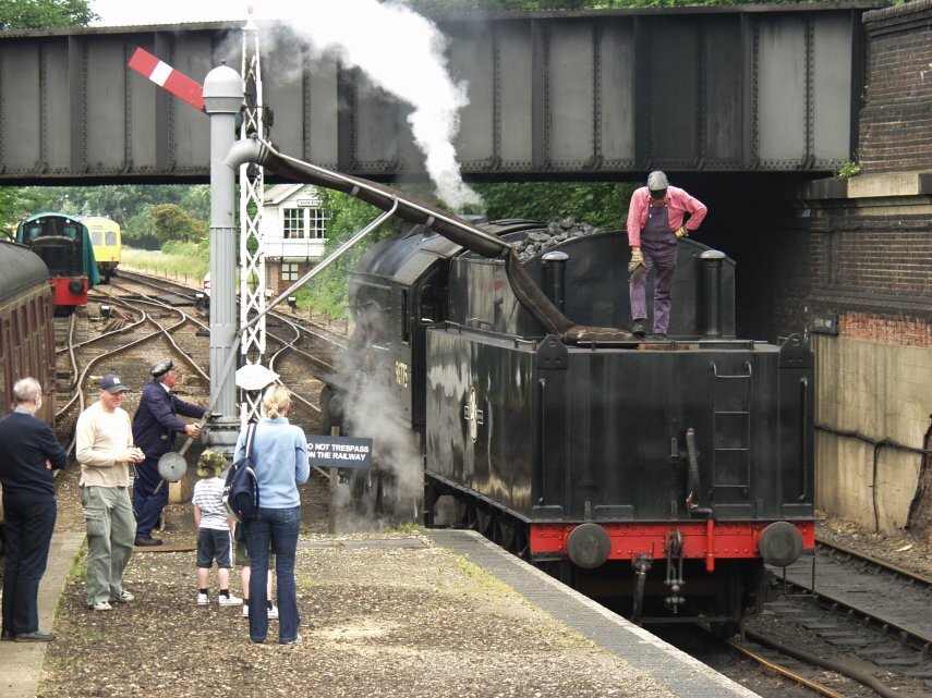 Steam locomotive taking on water at Sheringham Station on the North Norfolk Railway, Sheringham, Norfolk, England